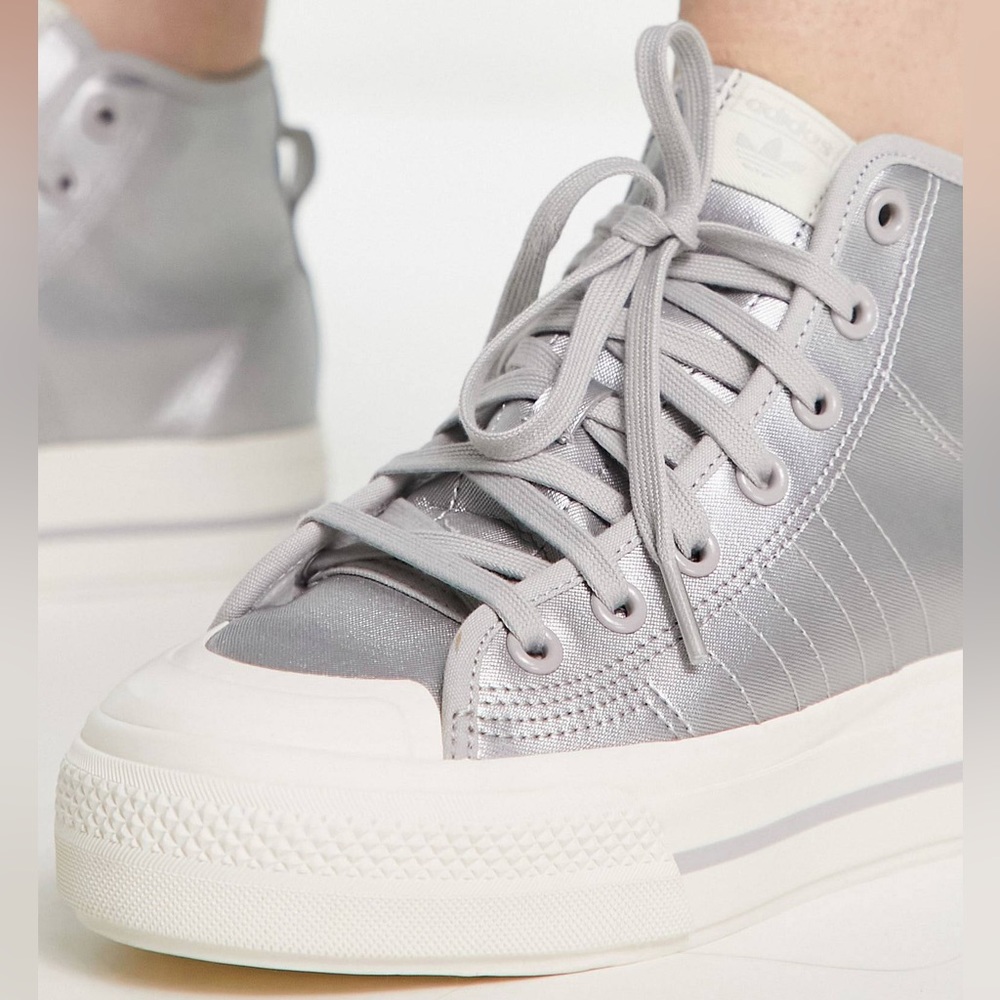 Women’s Adidas hi top platform sneaker in silver.